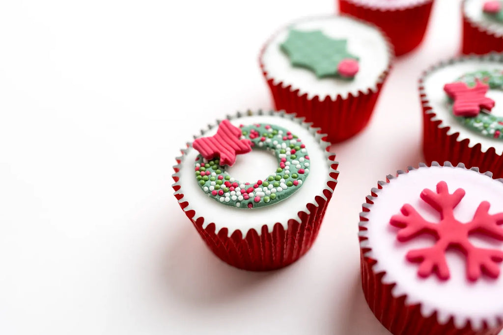 Decorative cupcakes with festive designs on a white background