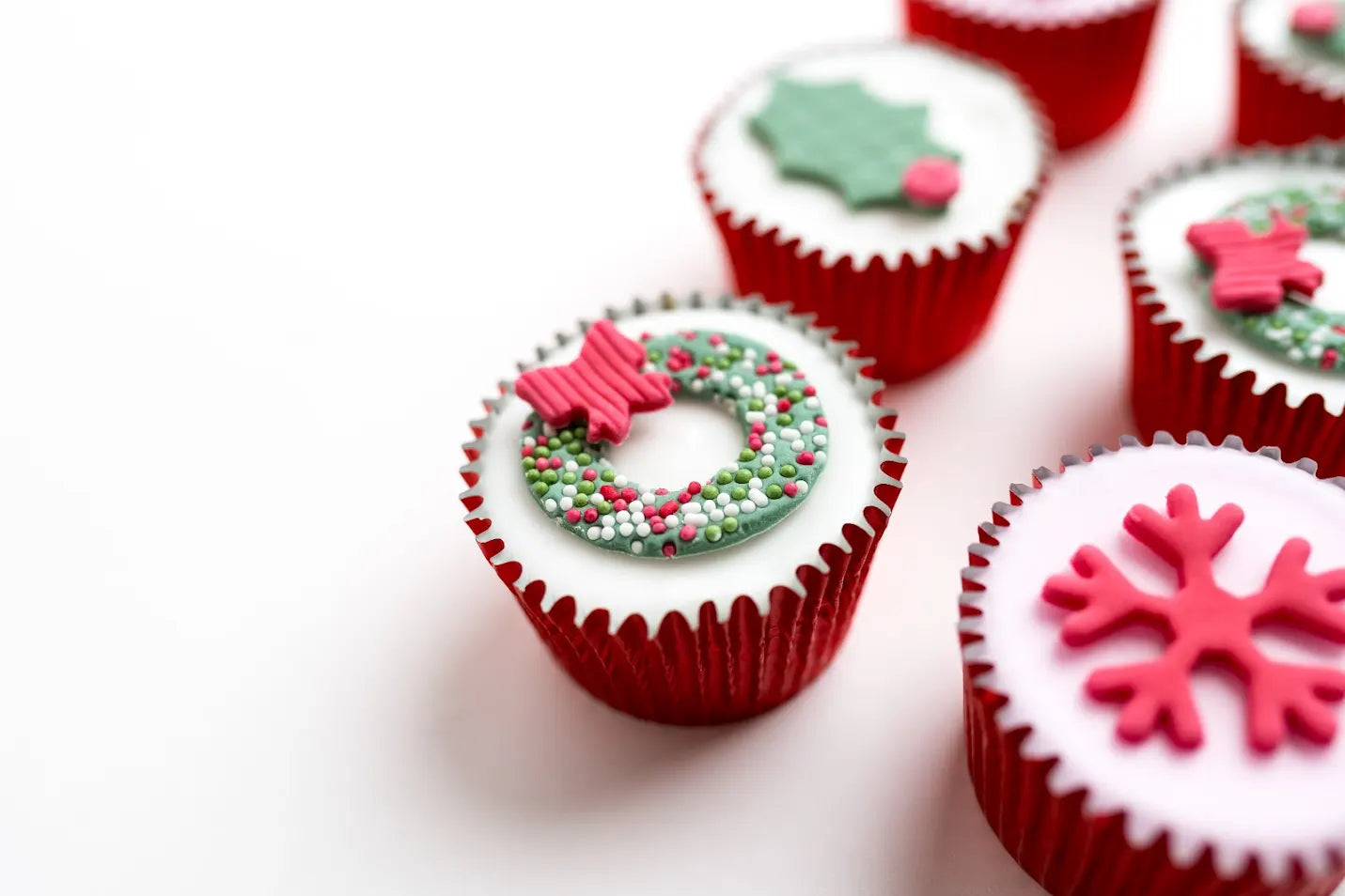Decorative cupcakes with festive designs on a white background
