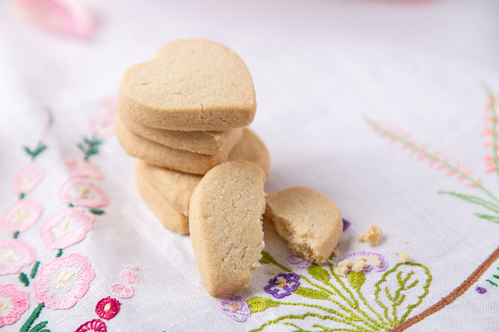 Stack of round Fiona Cairns cookies on a floral fabric background