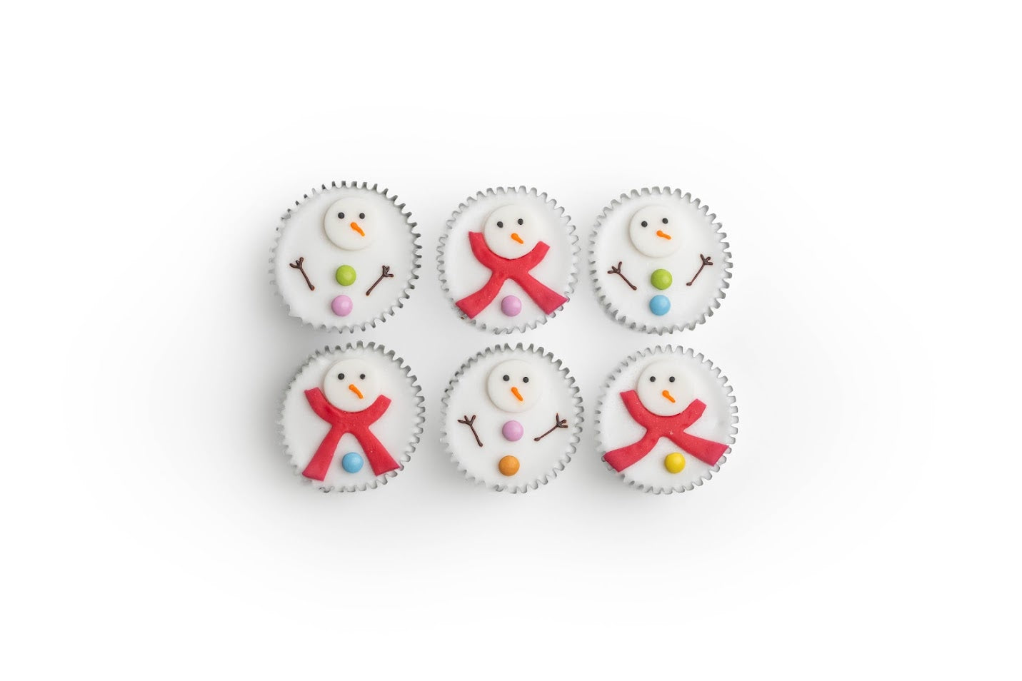 Six cupcakes decorated with snowman designs on a white background